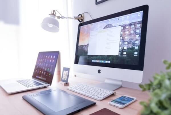 PC, Laptop, Tablet und Smartphone auf einem Schreibtisch.